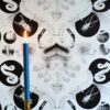 X-Ray Damask wallpaper by Daniel Heath in black colour on wall with candle|Rolls of X-Ray Damask wallpaper by Daniel Heath in black colour|X-Ray Damask wallpaper by Daniel Heath in black colour on wall with candle
